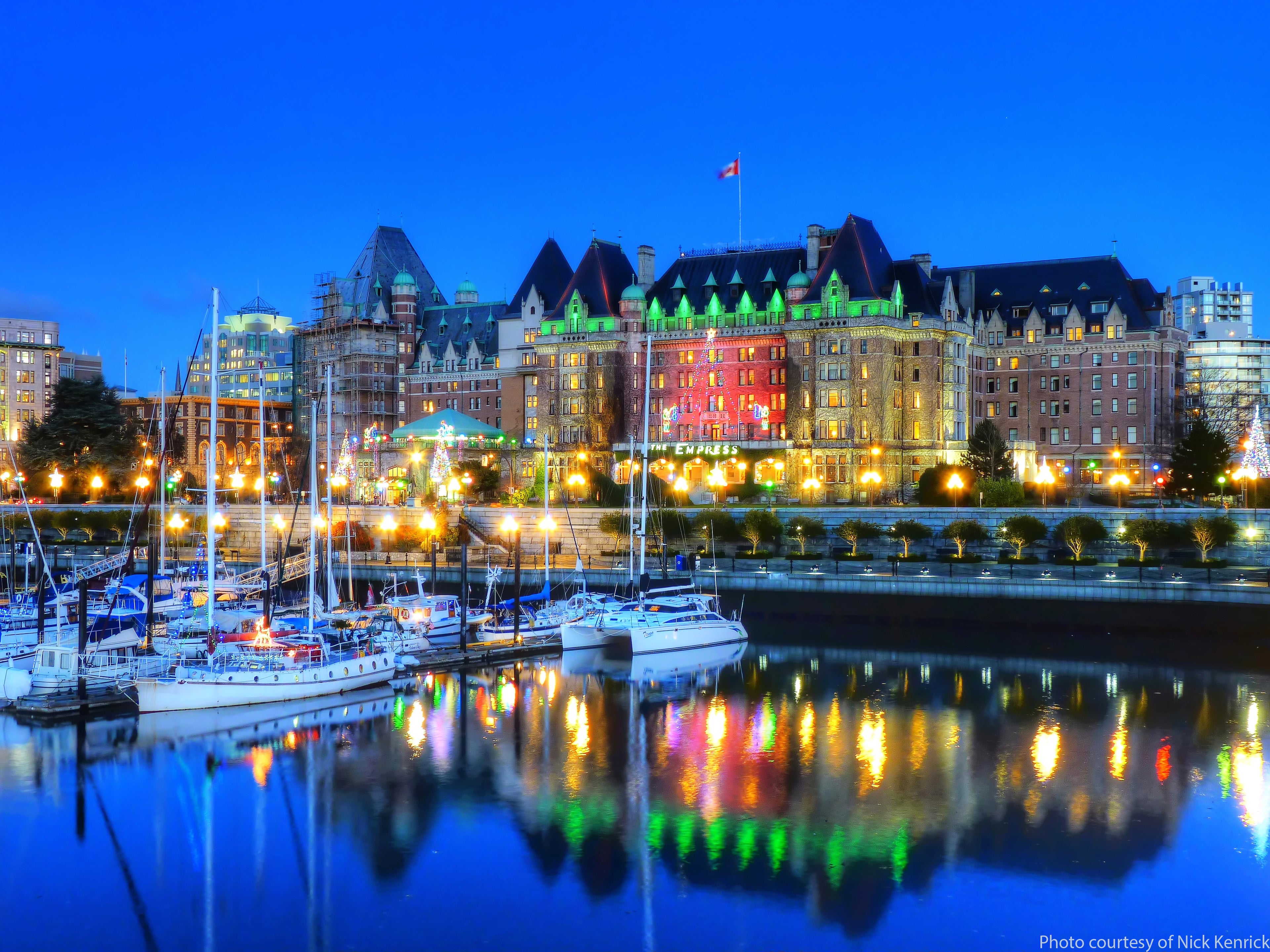 Harbor scene with illuminated buildings and boats at night. Photo Courtesy of Nick Kenrick 